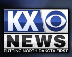 Logo of KX News, a CBS-affiliated television station, featuring the slogan "PUTTING NORTH DAKOTA FIRST.
