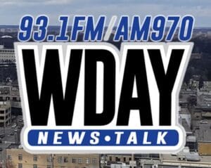 Logo of WDAY News/Talk radio station with 93.1FM and AM970 frequencies, against a cityscape background.