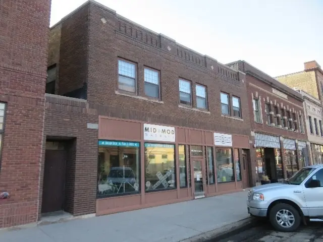 A multi-story historic building with street-level storefronts — commercial building inspected by Nordic Inspections in Fargo, ND.
