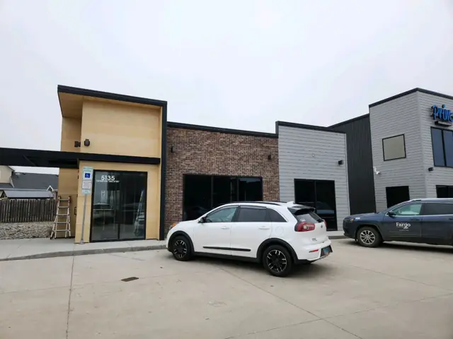 An office building with a landscaped entrance, a commercial building inspected by Nordic Inspections in Fargo, ND.
