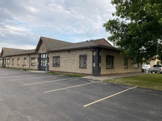 An office building with a landscaped entrance, a commercial building inspected by Nordic Inspections in Fargo, ND.