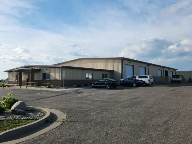 An office/warehouse with a paved lot — commercial building inspected by Nordic Inspections in Fargo, ND.
