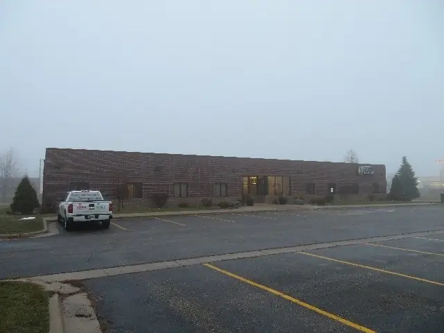 An office/warehouse with a paved lot — commercial building inspected by Nordic Inspections in Moorhead, MN.