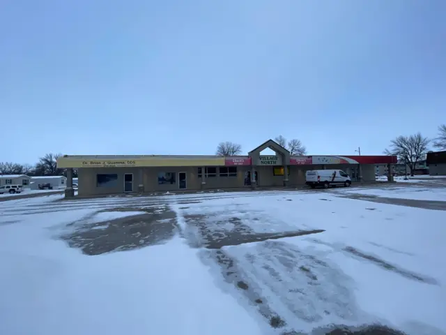 A strip retail center with several storefronts, a commercial building inspected by Nordic Inspections in Wahpeton, ND.